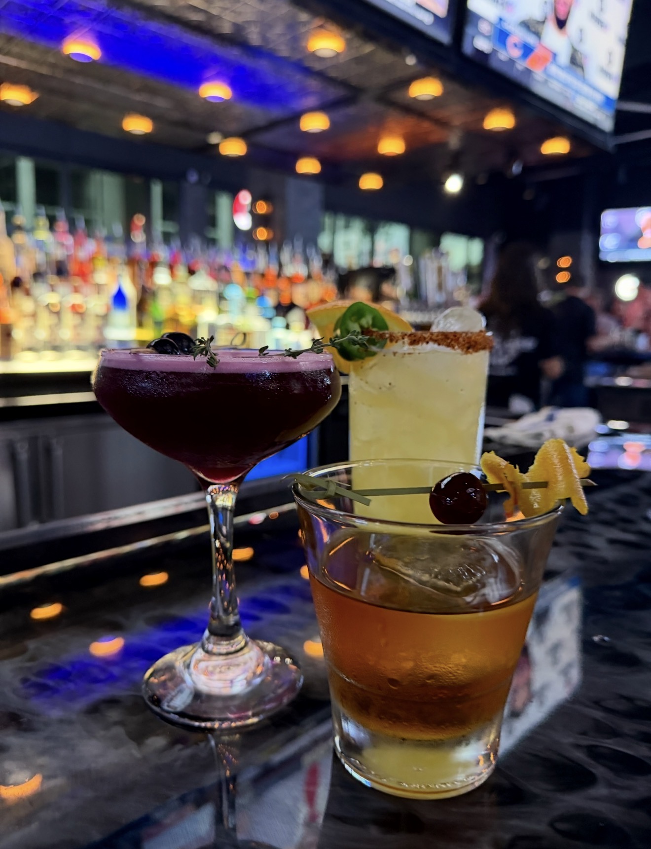 Three signature cocktails on the bar top