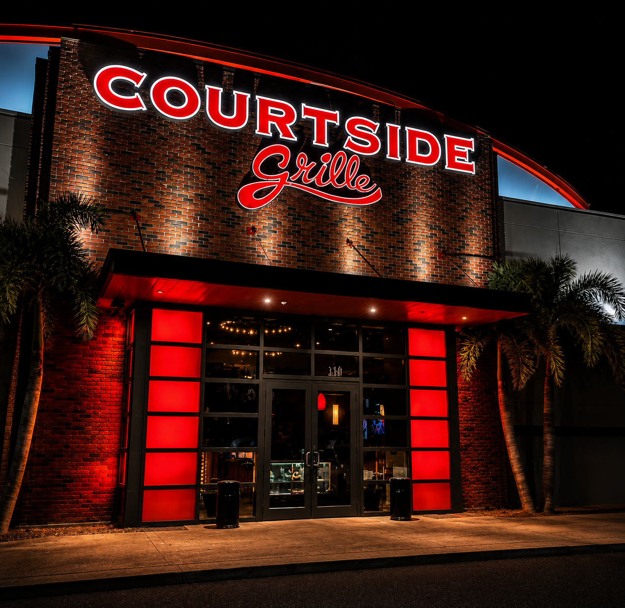 Courtside Grille storefront lit up at night