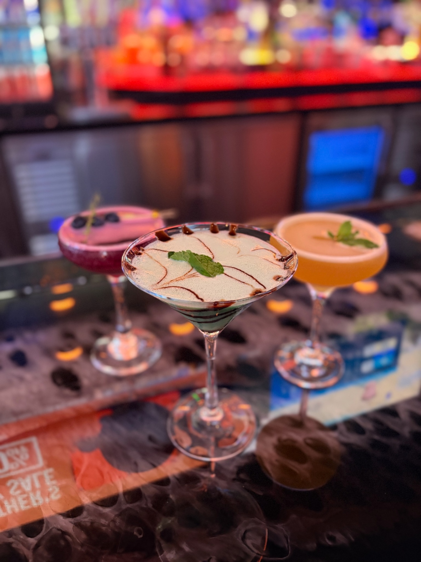 Chocolate-drizzled grasshopper martini in focus at the bar