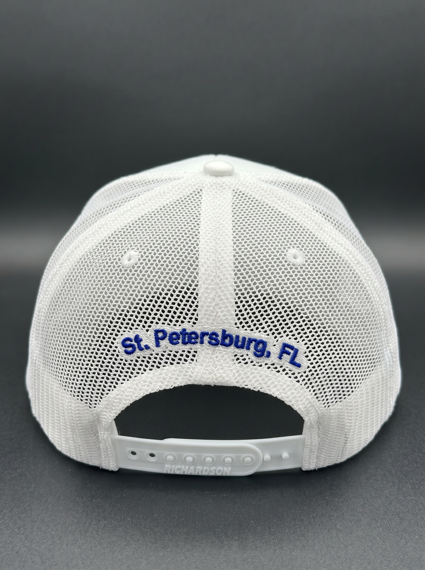 Back of the white Back Bar trucker hat with 'St. Petersburg, FL' embroidery